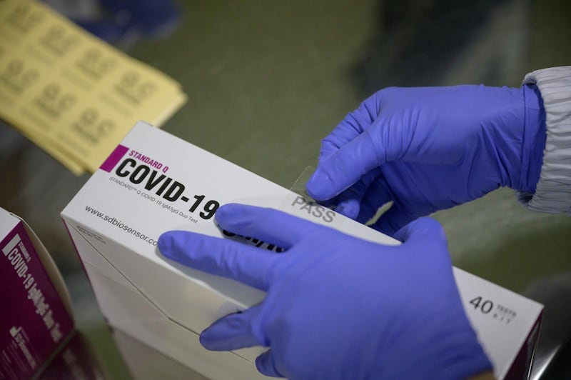 Covid-19 novel coronavirus testing kits are packaged on a production line at the SD Biosensor bio-diagnostic company near Cheongju, south of Seoul. AFP