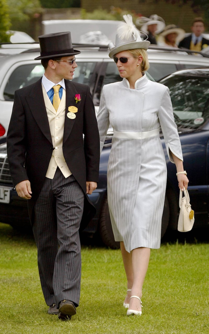 Zara Phillips, wearing a silver dress and hat, with then-boyfriend Richard Johnson arrive for Ladies Day at Royal Ascot on June 20, 2002. Getty Images 