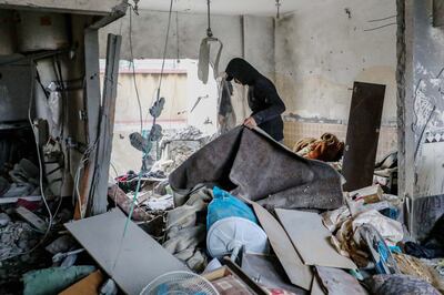 A man inspects the damage to his home and recovers items after Israeli air strikes on Tuesday in Gaza. Getty Images