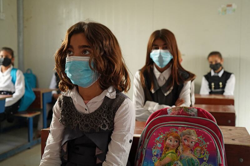 Girls sit in class on the first day of school in the camp for displaced people in Sharya.