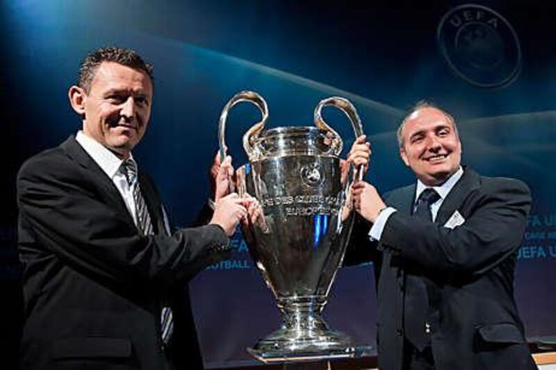 Young Boys' official Alain Baumann, left, and Spurs' Darren Eales with Champions trophy.