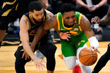 Utah Jazz guard Donovan Mitchell (45) beats Toronto Raptors guard Fred VanVleet (23) to a loose ball during the second half of an NBA basketball game Friday, March 19, 2021, in Tampa, Fla. (AP Photo/Chris O'Meara)