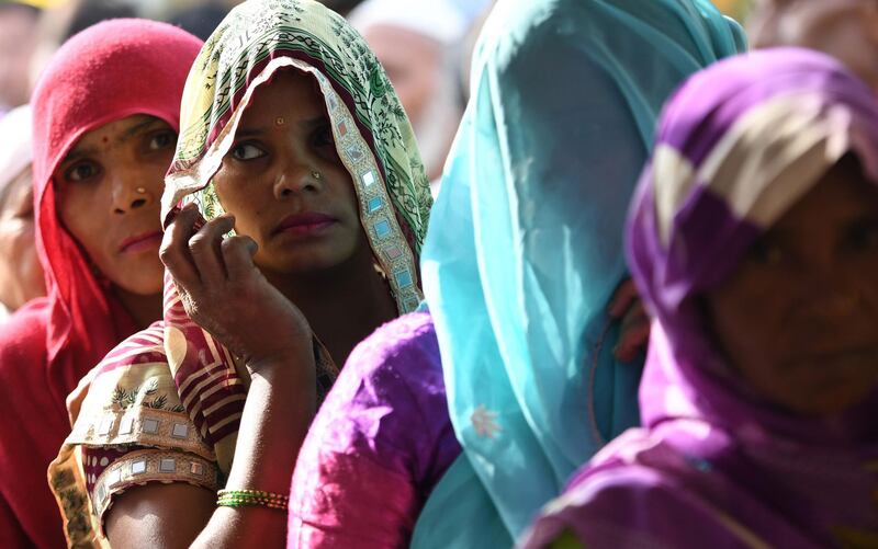 Indian women stand in a queue to caste their vote at a polling station during the India's general election in Kawaal village near Muzaffarnagar, in the northern Indian state of Uttar Pradesh, on April 11, 2019. India's mammoth six-week general election kicked off April 11, with polling stations in the country's northeast among the first to open. / AFP / Money SHARMA
