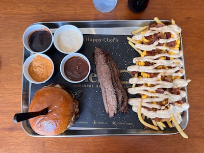 Brisket, ribs and burgers are accompanied by barbecue, sriracha, chilli and a house dip at Chef's Smokehouse. Nick Watkins / The National