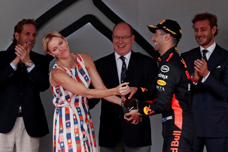 Princess Charlene, in multi-coloured Akris, jokes with Daniel Ricciardo after the Monaco Formual One Grand Prix on May 27, 2018. Reuters