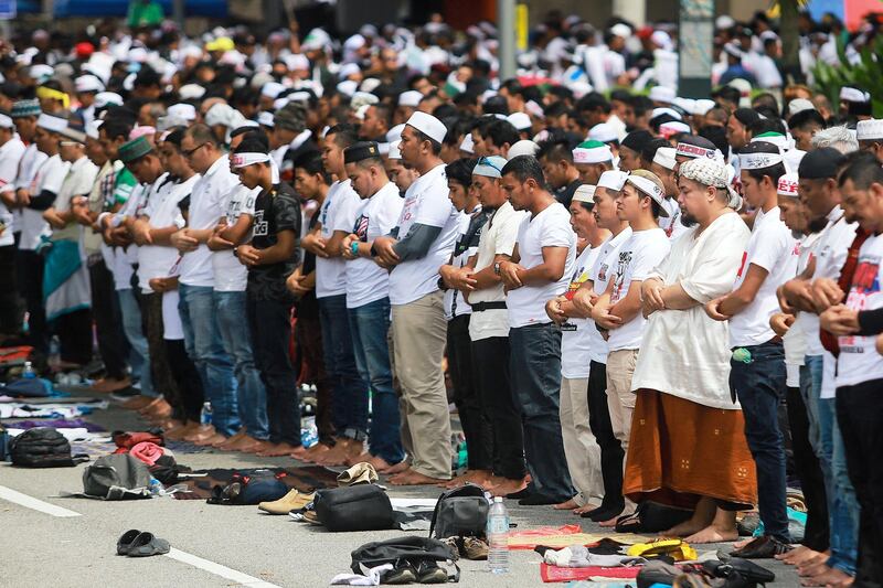 People pray before an Anti-ICERD (International Convention on the Elimination of All Forms of Racial Discrimination) mass rally in Kuala Lumpur, Malaysia. Reuters