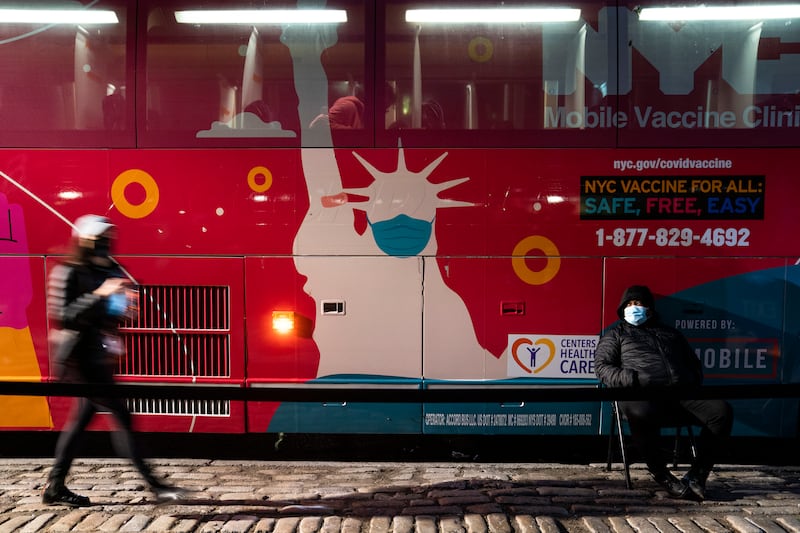 A mobile Covid-19 vaccination and booster shot site operates out of a bus on 59th Street, south of Central Park, in New York. AP