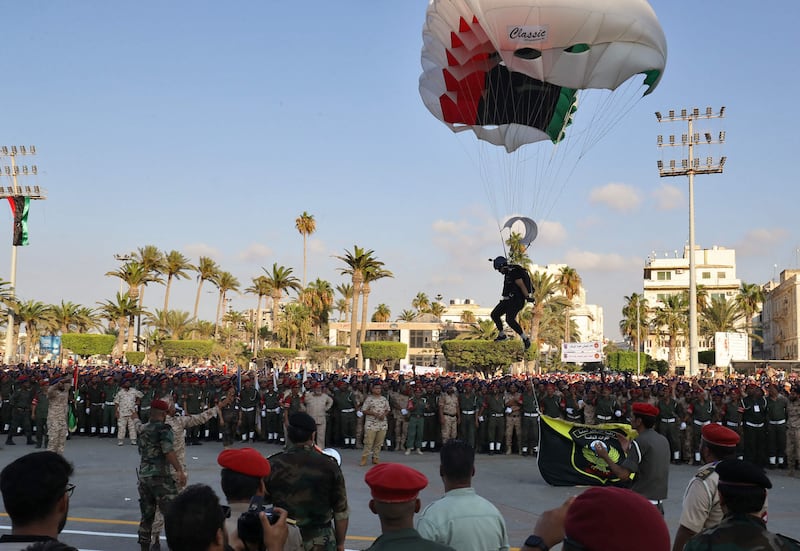 A parachutist makes a pinpoint landing during the parade.