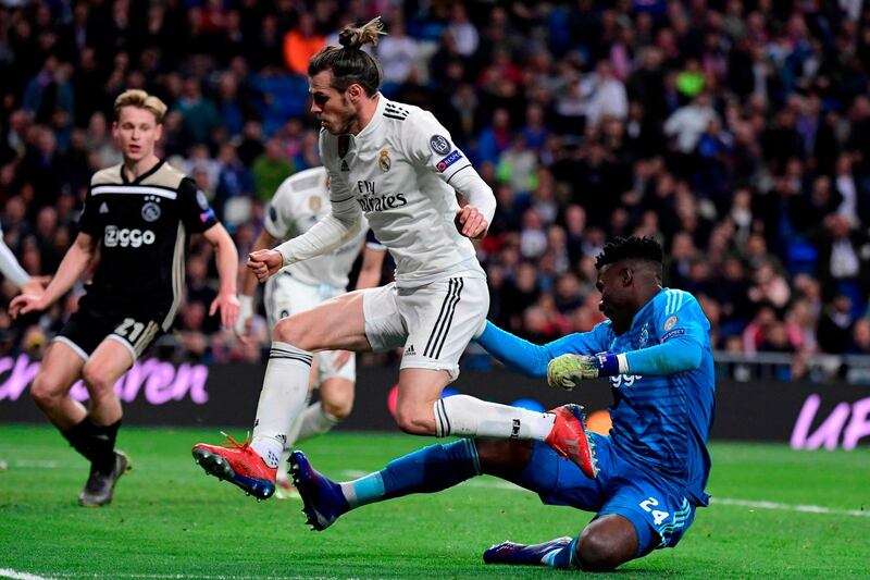 Real Madrid's Welsh forward Gareth Bale, centre, vies for the ball against Ajax's Cameroonian goalkeeper Andre Onana. AFP
