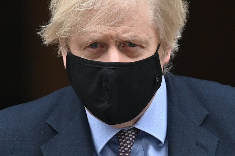 Britain's Prime Minister Boris Johnson, wearing a protective face covering to combat the spread of the coronavirus, leaves No 10 Downing Street in central London to take part in the weekly session of Prime Minister Questions at Parliament. He is facing a backlash from some of his own MPs over new coronavirus restrictions as he contends with a slump in support and questions about his future. AFP