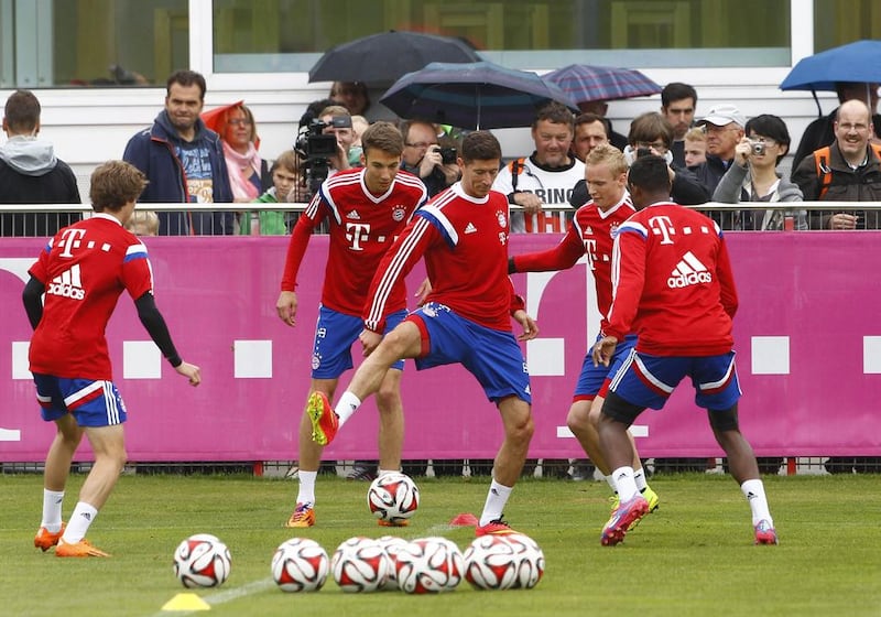 New Bayern Munich striker Robert Lewandowski, centre, warms up with teammates during a Bayern Munich training session on Wednesday. Michael Rehle / Reuters