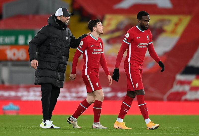 LIVERPOOL, ENGLAND - FEBRUARY 20: Jurgen Klopp, Manager of Liverpool consoles Andrew Robertson, and Divock Origi of Liverpool following their team's defeat in the Premier League match between Liverpool and Everton at Anfield on February 20, 2021 in Liverpool, England. Sporting stadiums around the UK remain under strict restrictions due to the Coronavirus Pandemic as Government social distancing laws prohibit fans inside venues resulting in games being played behind closed doors. (Photo by Laurence Griffiths/Getty Images)