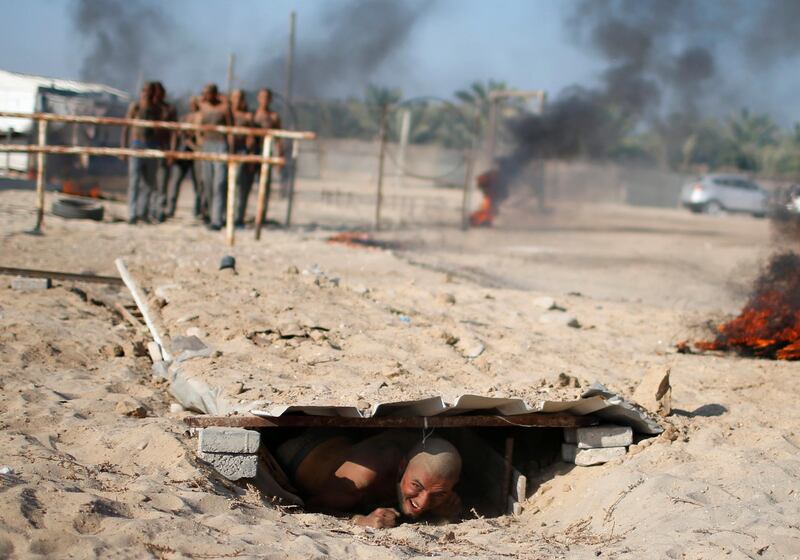 A Palestinian cadet crawls as he demonstrates his skills at a police college run by the Hamas-led interior ministry in Khan Younis in the southern Gaza Strip.  REUTERS
