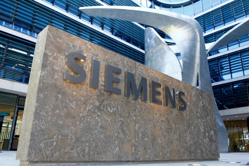 FILE - In this June 24, 2016 file photo the logo of German industrial conglomerate Siemens is pictured prior to the opening ceremony at the new headquarters in Munich, Germany.  Industrial equipment maker Siemens AG said Thursday net profit for the most recent quarter rose 7 percent to 1.46 billion euros ($1.72 billion) â€” and it announced an extension of CEO Joe Kaeser's contract until 2021. (AP Photo/Matthias Schrader, file)