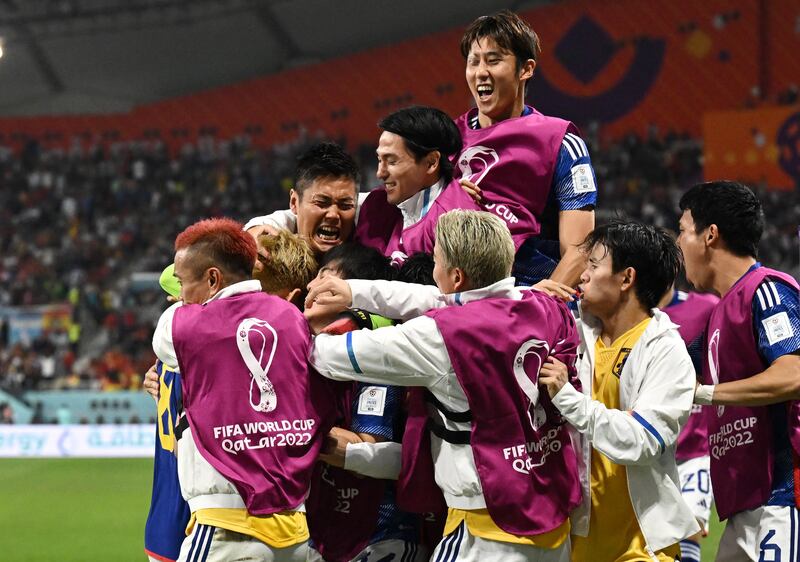 Japan's Ritsu Doan celebrates scoring their first goal with teammates. Reuters