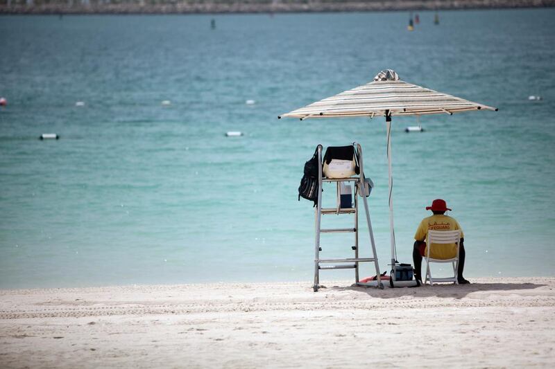 A life guard on the Corniche Beach in Abu Dhabi. It was 27°C on the Corniche at 9am this morning. Sammy Dallal / The National