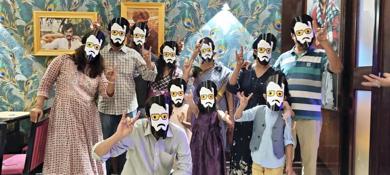 Guests at the new restaurant pose with Rajinikanth masks during the celebrations