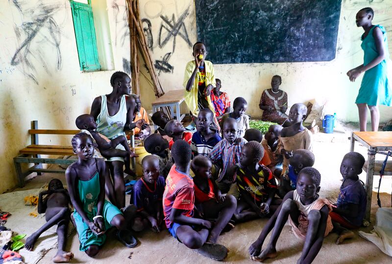 People gather inside a classroom at the Dibba Busin camp for South Sudanese refugees in Sudan's White Nile state after heavy flooding. South Sudan and Sudan are among a group of countries that all reported increases of between 100,000 and 500,000 people displaced internally during the year. AFP