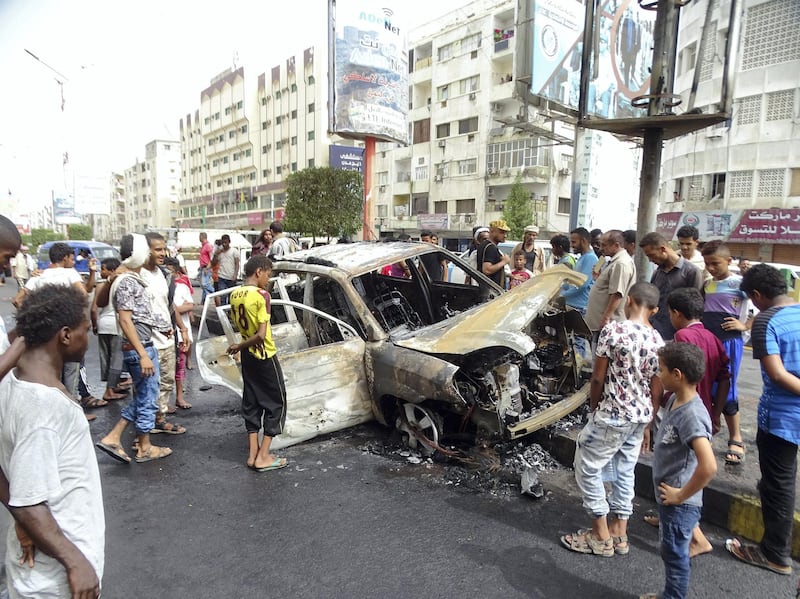 Crowd of people watching the car which was blown up in Madram street in Al-Mualla district in Aden this morning. Photo by Ali Mahmood 