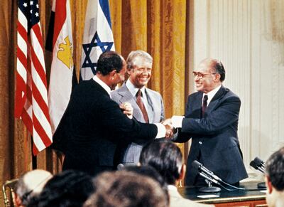Egyptian president Anwar Al Sadat, Israeli premier Menachem Begin and US president Jimmy Carter shake hands in 1978, a year before the peace treaty was signed. AFP 