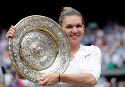 Tennis - Wimbledon - All England Lawn Tennis and Croquet Club, London, Britain - July 13, 2019  Romania's Simona Halep poses with the trophy as she celebrates after winning the final against Serena Williams of the U.S.  Ben Curtis/Pool via REUTERS