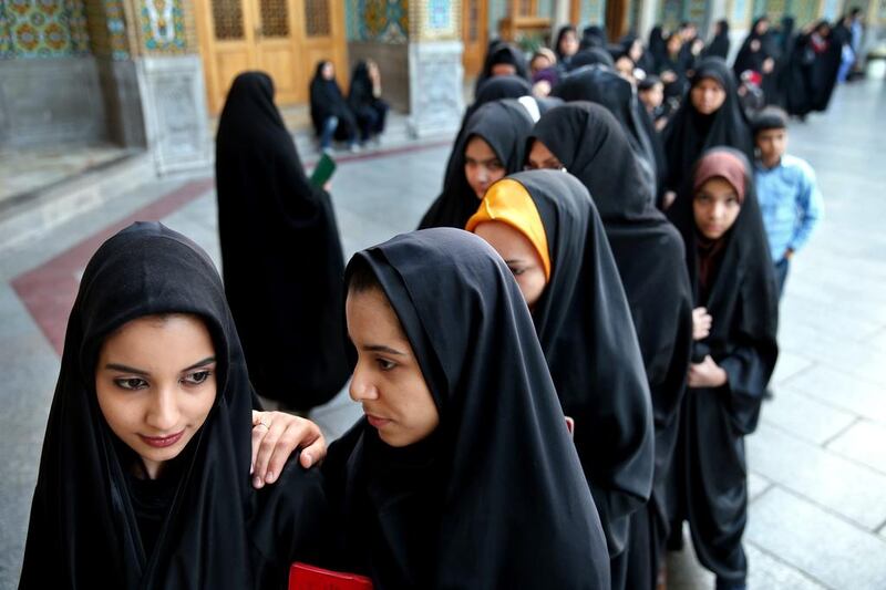 Iranian women stand in line at a polling station during the parliamentary and Experts Assembly elections in Qom, south of Tehran, Iran. Ebrahim Noroozi / AP Photo