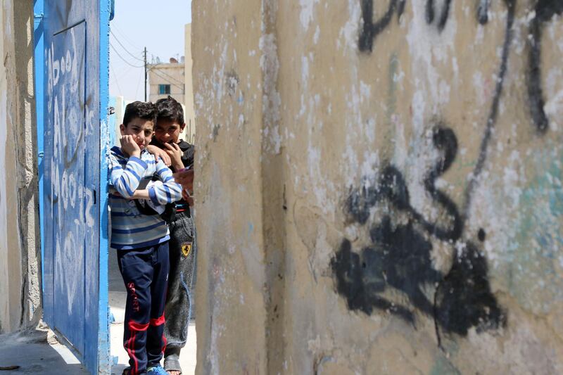 Schoolchildren stand at the gate of the UNRWA AL Jofeh elementary school in Jofeh district in Amman, Jordan. (Salah Malkawi for The National)