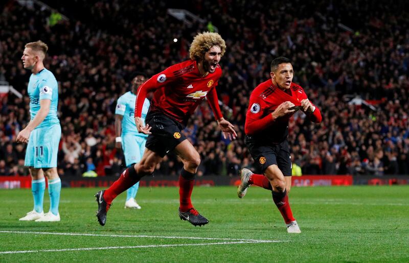 Soccer Football - Premier League - Manchester United v Newcastle United - Old Trafford, Manchester, Britain - October 6, 2018  Manchester United's Alexis Sanchez celebrates scoring their third goal with Marouane Fellaini   REUTERS/Phil Noble  EDITORIAL USE ONLY. No use with unauthorized audio, video, data, fixture lists, club/league logos or "live" services. Online in-match use limited to 75 images, no video emulation. No use in betting, games or single club/league/player publications.  Please contact your account representative for further details.