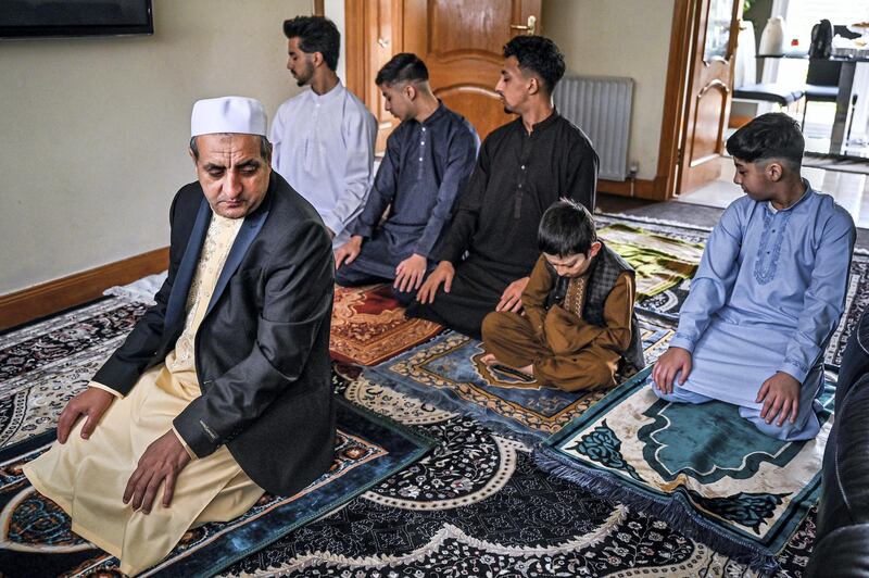 GLASGOW,UNITED KINGDOM - MAY 24: Mohammad Asif and his sons Harun, Rohid, Sahil, Faqrhan and Sudias gather at their home to perform Eid Al-Fitr prayer after a month of fasting in the holy Islamic month of Ramadan during the coronavirus (Covid-19) pandemic on May 24, 2020 in Glasgow, United Kingdom. Muslims in the United Kingdom were having to celebrate at home and not go to Mosques to avoid spreading the coronavirus.  (Photo by Jeff J Mitchell/Getty Images)