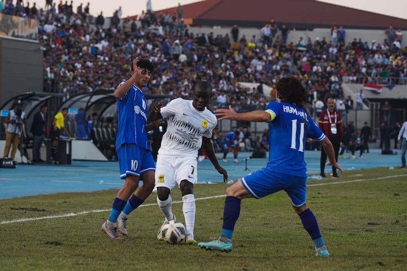 Al Ittihad's N'Golo Kante, centre, deals with the attention of two Air Force Club players.