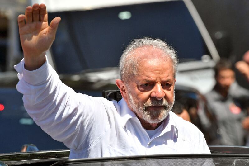 Mr da Silva waves while leaving the polling station in Sao Paulo. AFP