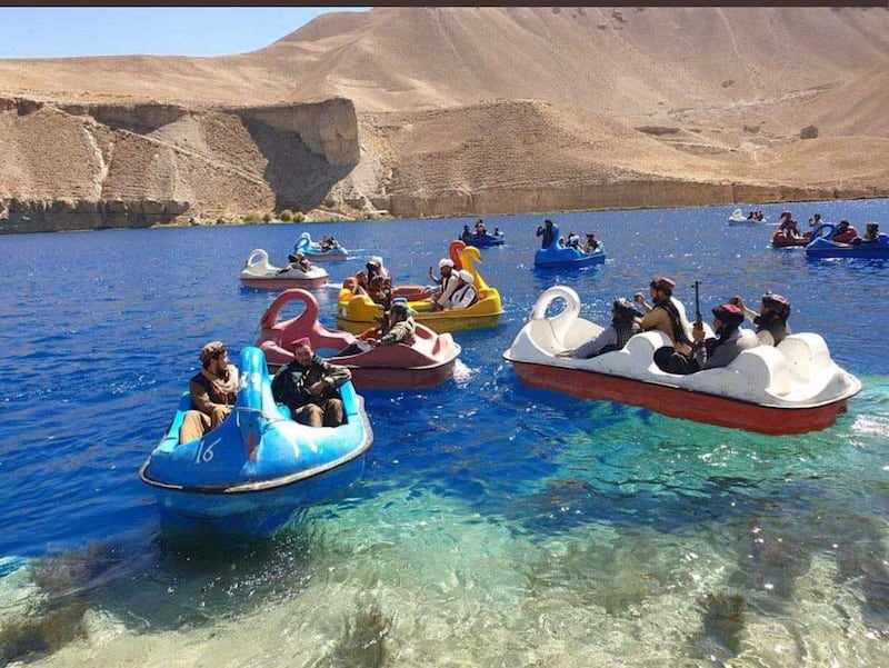 Taliban fighters ride boats on Band-e Amir lake, once a popular destination for local tourists,  in Afghanistan's Bamyan province.