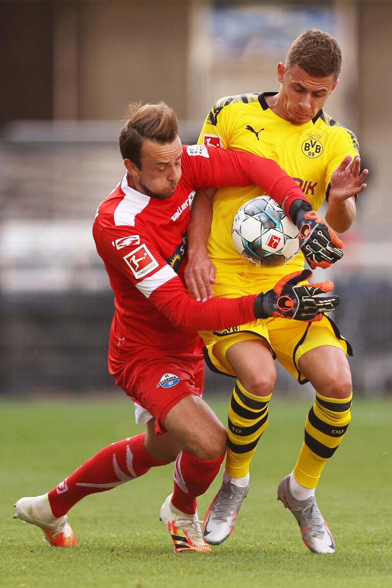 Thorgan Hazard of Borussia Dortmund battles for the ball with goalkeeper Leopold Zingerle of SC Paderborn. EPA