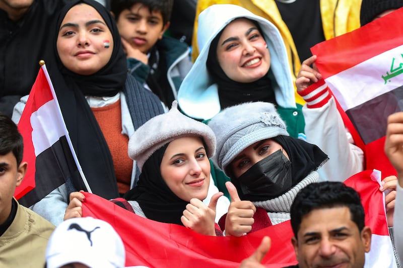 Fans wave Iraqi flags at the Basra International Stadium in Basra. AP