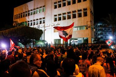 A recent protest outside the Sidon branch of the Banque du Liban, Lebanon's Central Bank. The central bank's governor, Riad Salameh, has told the Association of Banks in Lebanon he intends to issue a circular cutting interest rates in a bid to revive the country's flagging economy and reduce the risk of debt defaults. AFP 