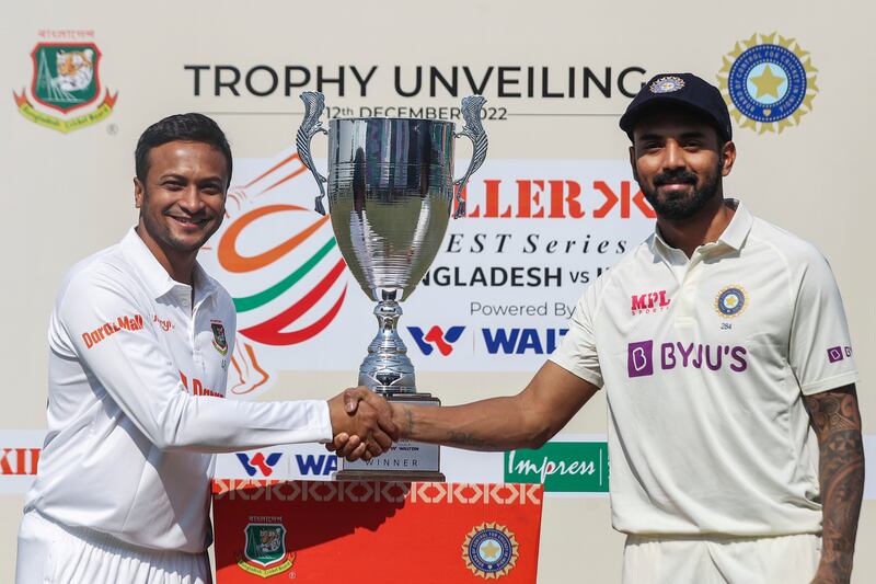 Bangladesh captain Shakib Al Hasan, left, and his Indian counterpart KL Rahul with the Test series trophy in Chattogram. AP