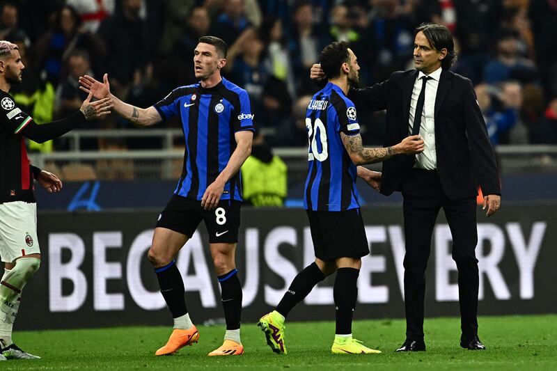 Inter Milan's manager Simone Inzaghi, right, congratulates his Turkish midfielder Hakan Calhanoglu at the end of the Champions League semi-final second-leg against AC Milan. AFP