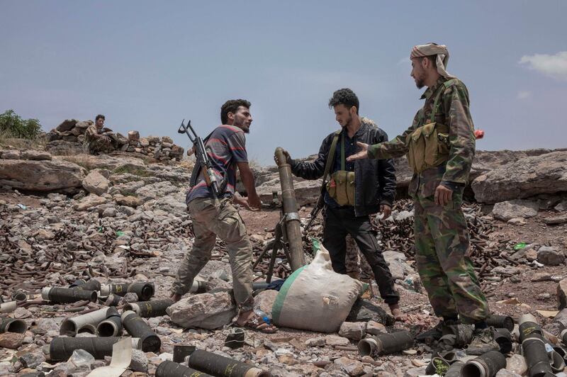 FILE - In this Monday, Aug. 5, 2019, file photo, fighters from a militia known as the Security Belt, that is funded and armed by the United Arab Emirates, discuss launching a mortar towards Houthi rebels, in an area called Moreys, on the frontline in Yemen's Dhale province. Saudi Arabia and the United Arab Emirates pledged Monday, Aug. 26, 2019, to keep their floundering coalition war against Yemen's Houthi rebels together after an Emirati troop pullout and the rise of the southern separatists they supported. (AP Photo/Nariman El-Mofty, File)