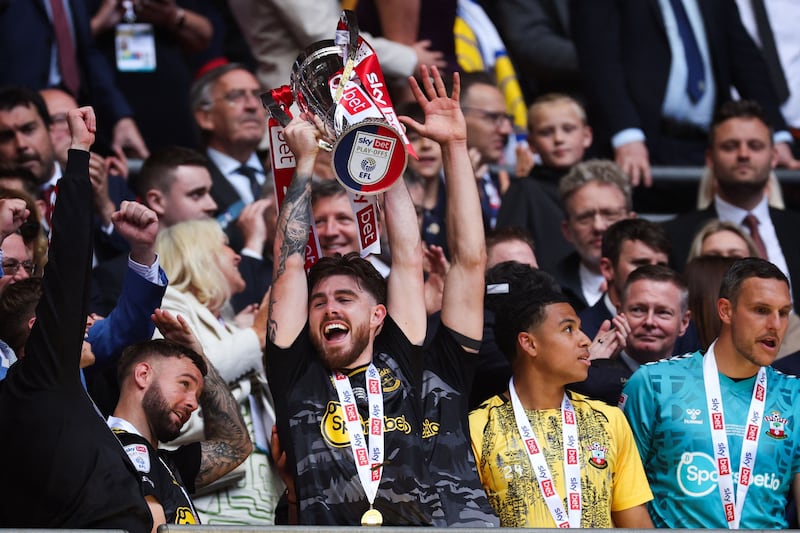 Southampton's Irish defender Ryan Manning lifts the Championship play-off trophy. AFP
