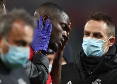 Soccer Football - FA Cup - Third Round - Manchester United v Watford - Old Trafford, Manchester, Britain - January 9, 2021 Manchester United's Eric Bailly receives medical attention after sustaining an injury Action Images via Reuters/Carl Recine