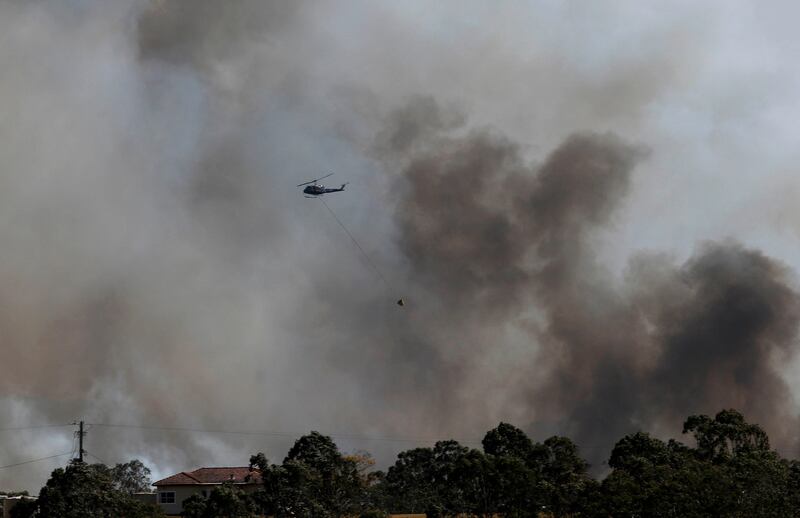 A water bombing helicopter fights a bushfire in Richmond Vale, near New South Wales, Australia. Darren Pateman / EPA