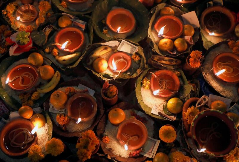Oil lamps along with various offerings offered by the devotees. Reuters