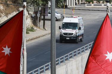 An ambulance drives along an empty road during a Covid-19 lockdown in Jordan's capital Amman on October 9, 2020. AFP