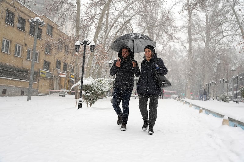 A victory sign as heavy snow falls in Tehran, the capital of Iran. AP