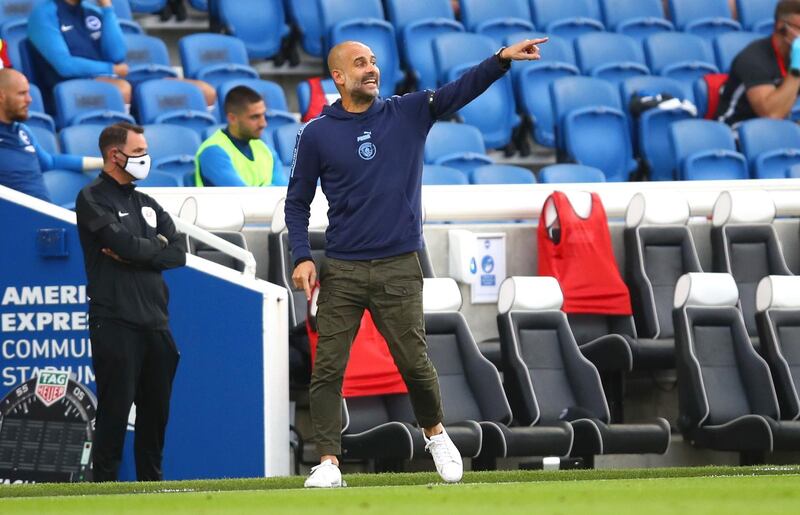 Pep Guardiola gives his team instructions at American Express Community Stadium. Getty