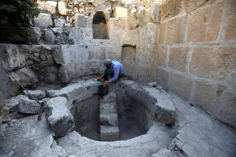 An archaeologist works at a historical monastery site in Taffouh village near the West Bank City of Hebron. EPA