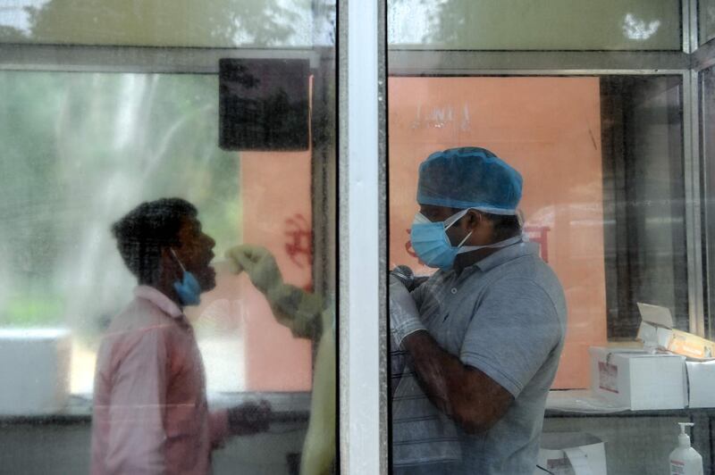 A medical staff member takes a sample from a man for a Covid-19 coronavirus test at Lala Lajpat Rai Memorial hospital in Meerut in Uttar Pradesh state. AFP
