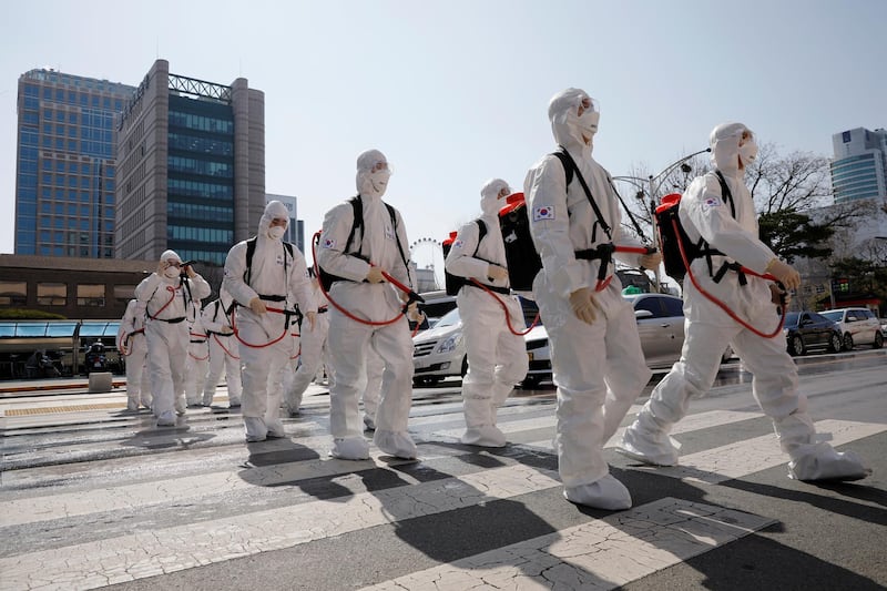 South Korean soldiers wearing protective gear walk on a street in front of Seoul's city hall. Reuters