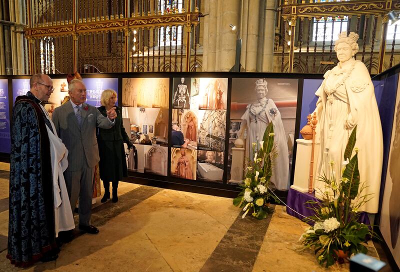 The king and queen consort are shown a scaled replica of a statue of Queen Elizabeth on a visit to York Minster. AFP