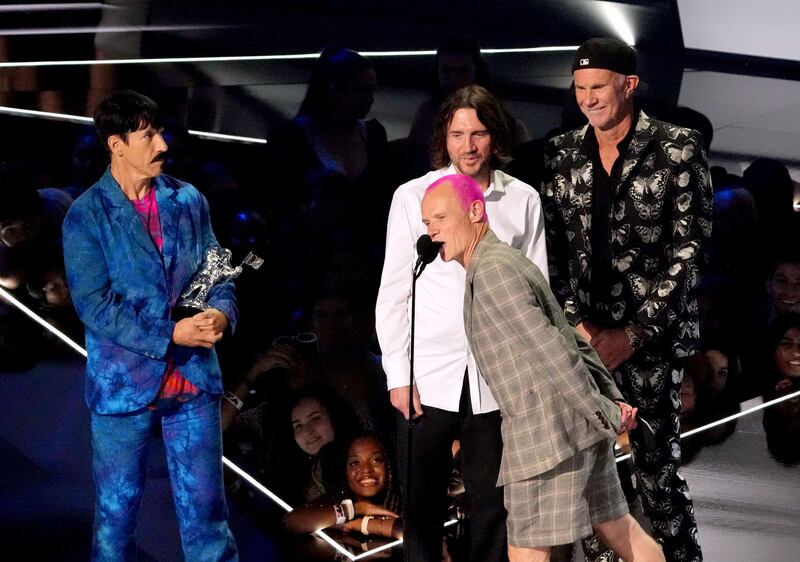 Anthony Kiedis, Flea, John Frusciante and Chad Smith of Red Hot Chili Peppers accept the Best Rock award for 'Black Summer'. AFP
